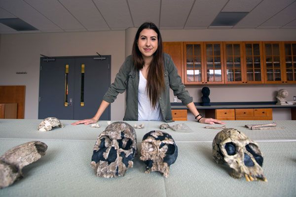 Undergraduate student Klara Komza with skulls in a laboratory